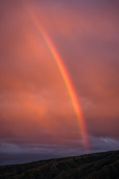 Vibrant Rainbow Arcs Across a Colorful Evening Sky