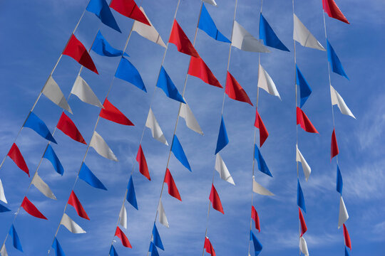 Colorful Flags Against Blue Sky