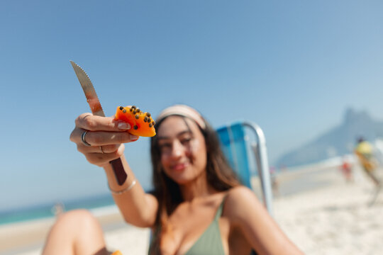Offering a Slice of Papaya on the Beach
