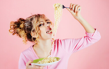 Sexy girl eating noodles. Beautiful woman with plate of instant noodles. Morning breakfast. Woman...