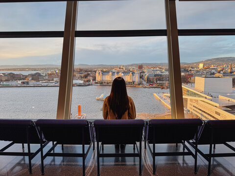 Woman Looking Out Over City and Harbor
