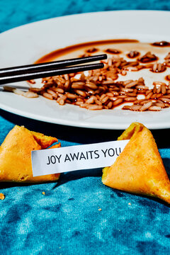 the message joy awaits you in an open fortune cookie