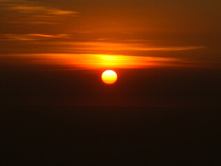 defaultA breathtaking sunrise with vibrant orange hues painting the sky, casting warm light over the landscape and creating a serene, peaceful atmosphere.