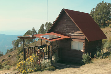 Scenic view of eco-friendly cabins nestled in the forest, blending with nature, offering sustainable lodging surrounded by lush green trees and fresh mountain air