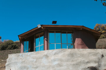 Scenic view of eco-friendly cabins nestled in the forest, blending with nature, offering...