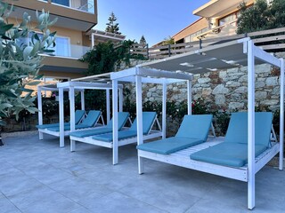Sun-tanning sun loungers by the pool at a five stars resort villa in Heraklion Crete Greece