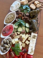 Charcuterie board variety of meat, green vegetables, fruits, and local cheese for lunch snack