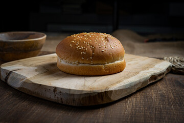 a hamburger bun on a wooden board
