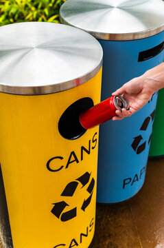 Mindful female recycling can to sustainable urban living