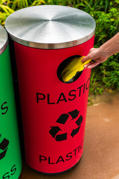 Hand disposing plastic waste