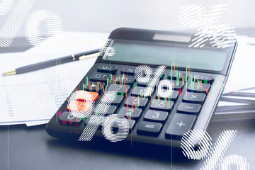 Calculator with percentage symbols and stock market chart overlay. Concept of interest rates with loan calculation, mortgage, finance, and economic analytics.