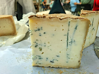 Handmade goat cheese display at a market in Spain showcasing local artisanal products