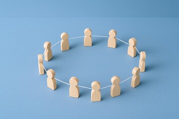 Obraz premium Teamwork Circle: Wooden Figures Connected by String Symbolizing Collaboration, Unity, Communication, and Teamwork in Business