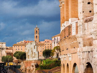 Rome historical center with ancient ruins, Capitoline Hill bell tower and the famous Coliseum
