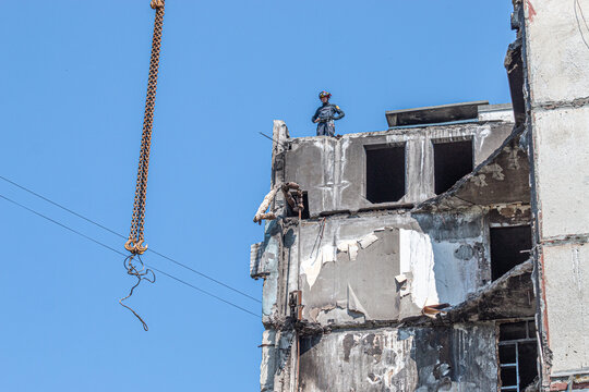 Ukrainian rescuer dismantles dangerous structures on a destroyed high-rise building