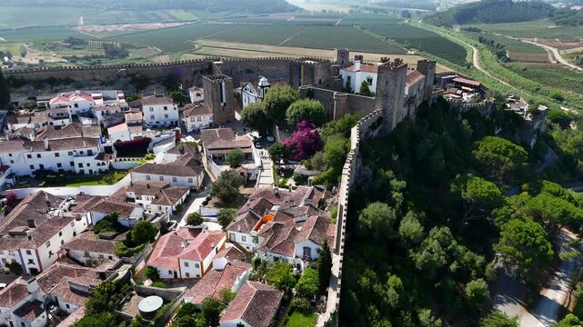 The medieval village of Obidos in Portugal.

Obidos sits on a hill surrounded by fortified walls. It's a famous place and tourist destination in Portugal. 4k.