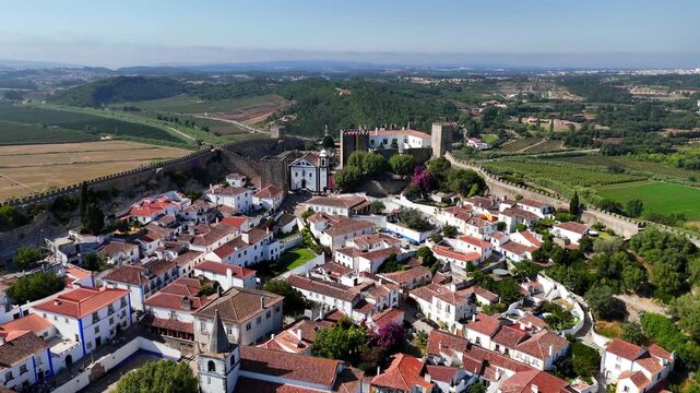 The medieval village of Obidos in Portugal.

Obidos sits on a hill surrounded by fortified walls. It's a famous place and tourist destination in Portugal. 4k.