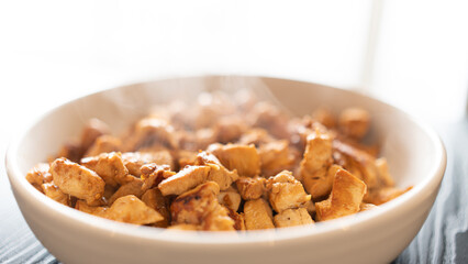 Juicy cubed chicken sautéed with garlic and minimal oil, steaming fresh. Healthy protein dish perfect for meal prep, fitness recipes, and food photography