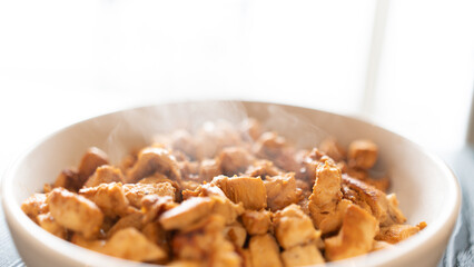 Juicy cubed chicken sautéed with garlic and minimal oil, steaming fresh. Healthy protein dish perfect for meal prep, fitness recipes, and food photography
