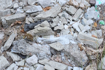 texture of white pieces of stones with cracks on the gray ground on the street