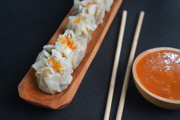 Steamed Dim Sum with Chili Sauce and Chopsticks