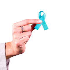 Woman’s hand holding a light blue ribbon over a transparent background. Symbol of prostate cancer...