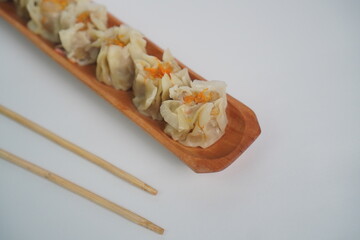 Steamed Shumai Dim Sum on a Wooden Plate
