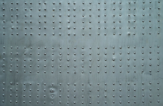 Abstract metal background. Old weathered silver metallic background. Vintage metal texture with rivets and bolts. Sheathing old plane. Old metal texture. High quality photo