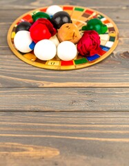 Colorful painted eggs on wooden platter