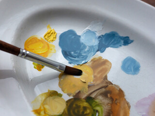 A brush and colorful stains