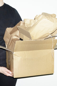 Person opening brown cardboard mail parcel package delivery boxes
