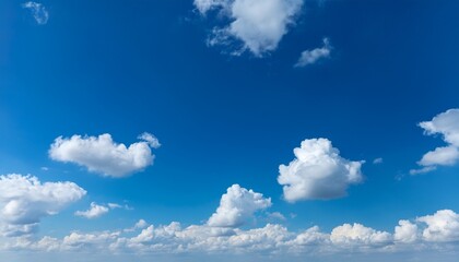 Fototapeta premium bright blue sky with scattered white cumulus clouds during daylight