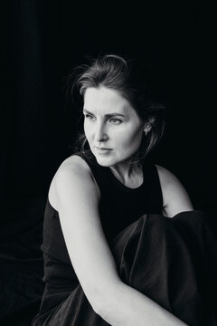 Woman posing thoughtfully in a dramatic portrait 