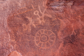 Petrolglyphs on the dramatic red sandstone formation of Atlatl Rock in Valley of Fire state park...