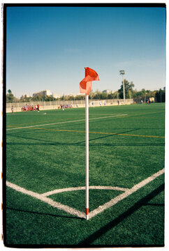 Red flag on white rod at the corner of soccer field
