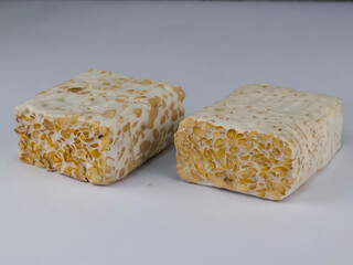 Sliced of Tempeh or tempe isolated on white background . Tempeh is a traditional Indonesian food made from fermented soy beans. 
