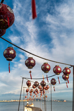 Red Chinese lanterns in sea breeze