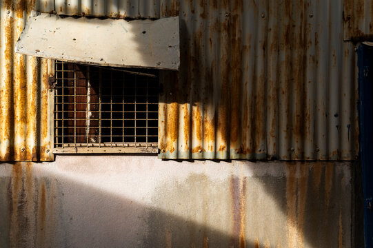 Rusty corrugated metal wall and shadowplay