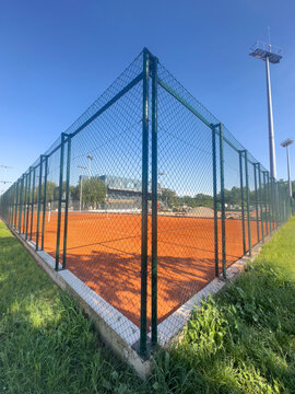 Orage tennis coart, green grass and blue sky