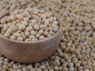 Soy Beans seeds in wooden bowl with soy beans background.