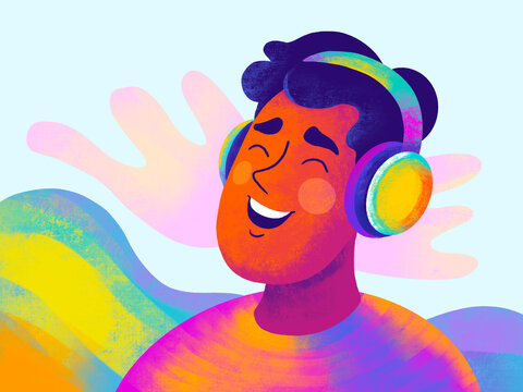 Joyful young man listens to music with vibrant headphones
