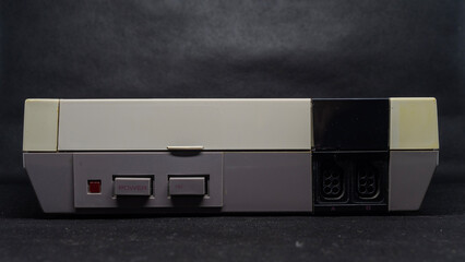 Vintage Gray Gaming Console on Black Background