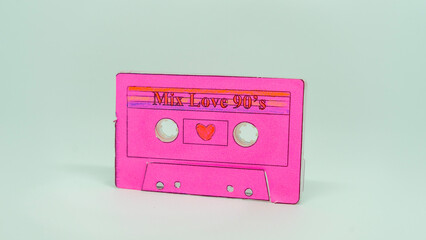 Obraz premium Retro Pink Cassette Tape with Heart on White Background