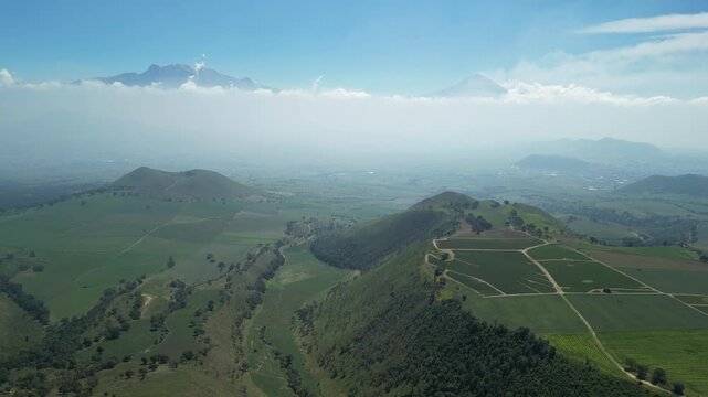 Aerial view of the Popocat&eacute;petl volcano in Mexico, seen from beautiful meadows. Mountains and volcanoes of Mexico, travel and vacation concept, 4k nature.
