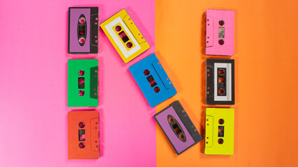 Colorful Audio Cassettes on Pink and Orange Backgrounds