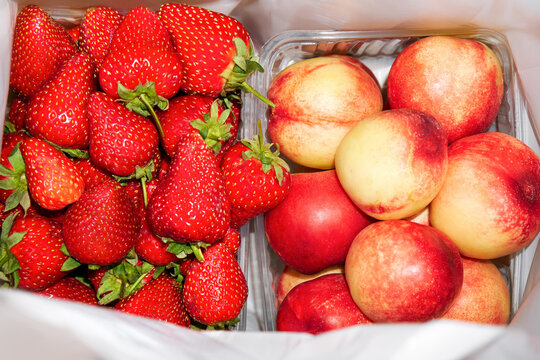 Fresh fruits and berries in a white bag. 