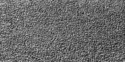 Textured surface of black asphalt with a rough, gritty appearance, showcasing the intricate details and patterns of the material, ideal for backgrounds and design projects. Banner with copy space