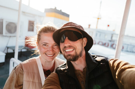 Couple Enjoys Sunny Day on Deck of a Cruise Ship in the Ocean
