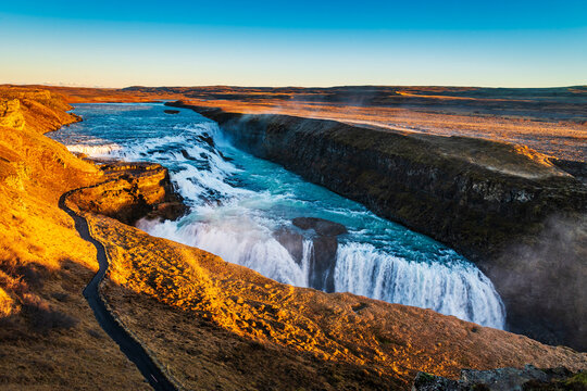 Dramatic view at Icelandic Gullfoss waterfall with low sunlight