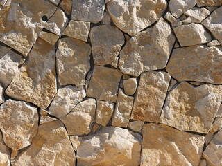 Dry stone wall consisting of irregularly shaped stones that have been joined together without...